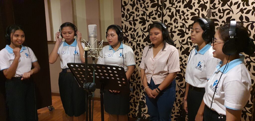 Indonesian girls recording a song in a recording studio